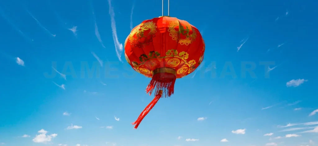 
Festive red chinese lantern hanging against a brilliant blue sky