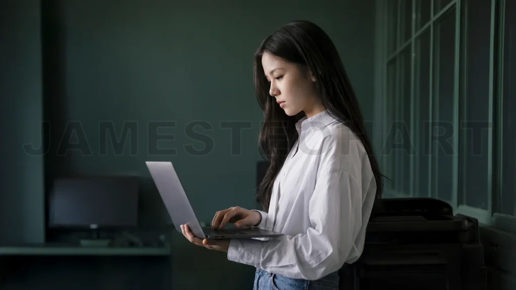 
Asian Businesswoman Working on Laptop in Office