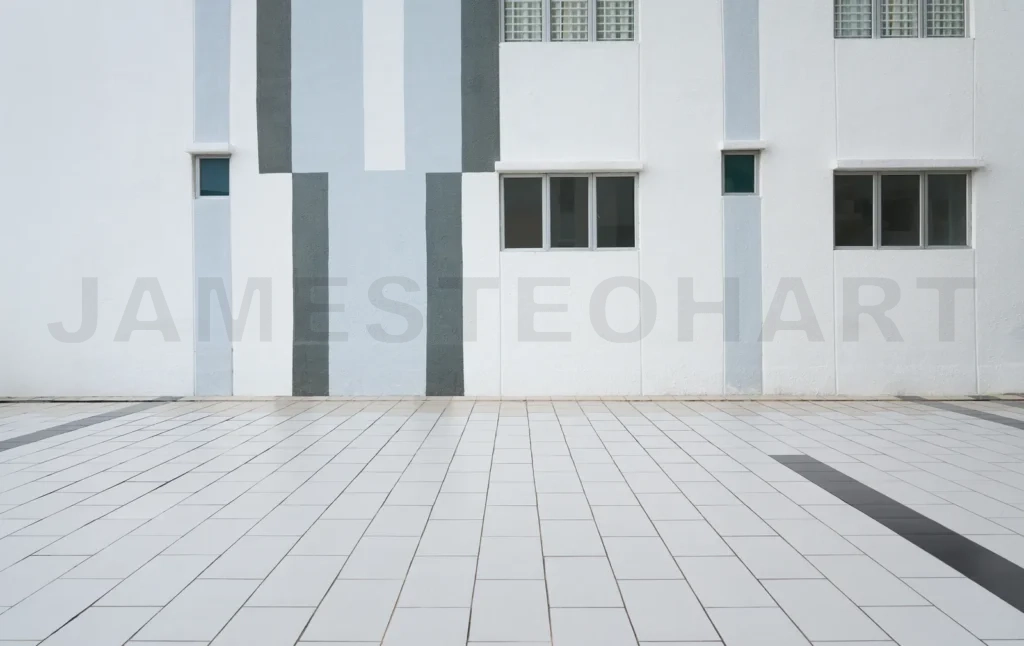 
Modern building facade with geometric pattern and empty tiled pa