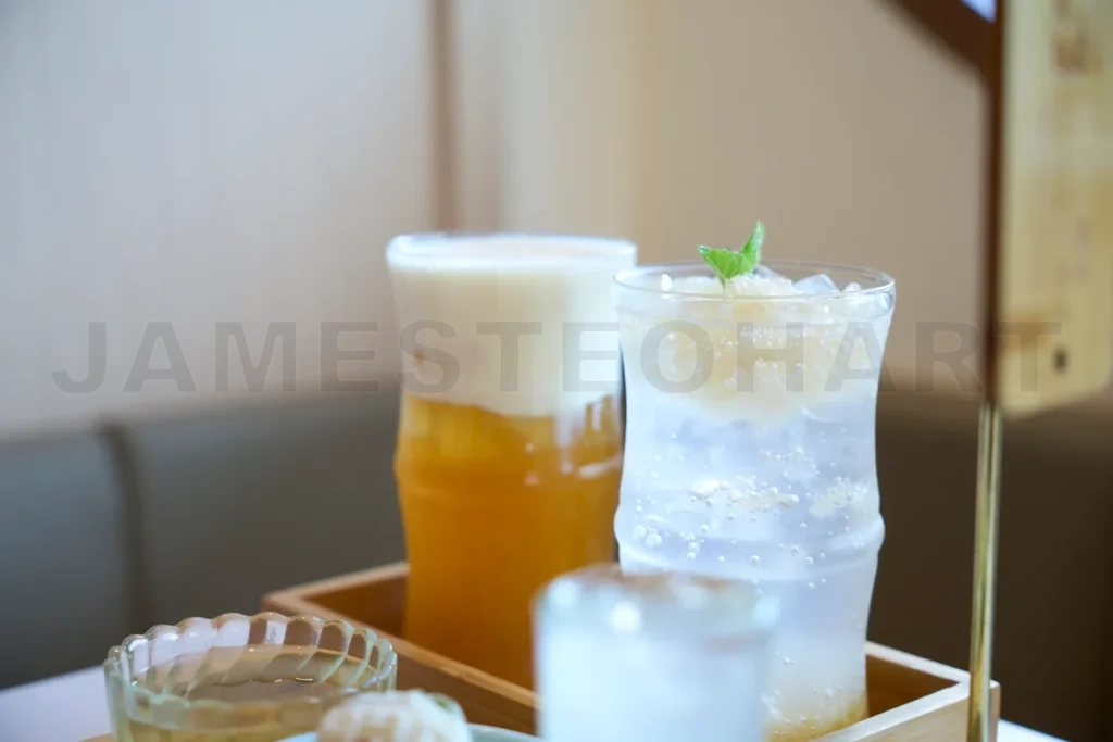 
Refreshing cold beverages with ice and mint on table in cafe