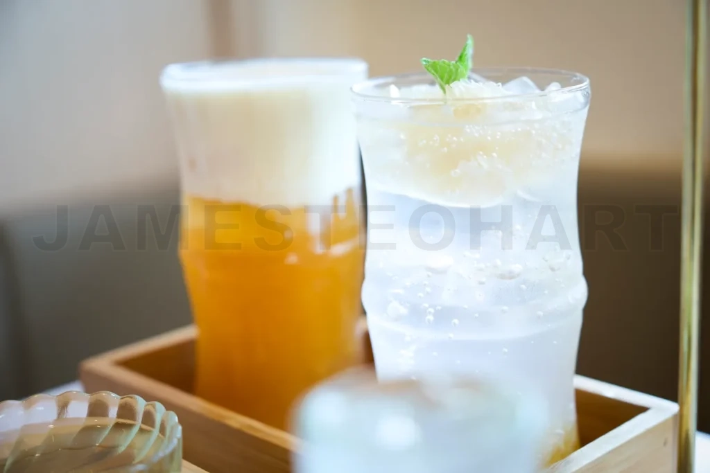 
Refreshing summer drinks with ice and fruit in fancy glasses