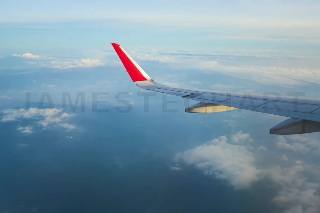 
Airplane is soaring above the clouds at sunset