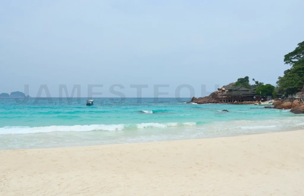 
Boat sailing on turquoise water near tropical resort in redang i