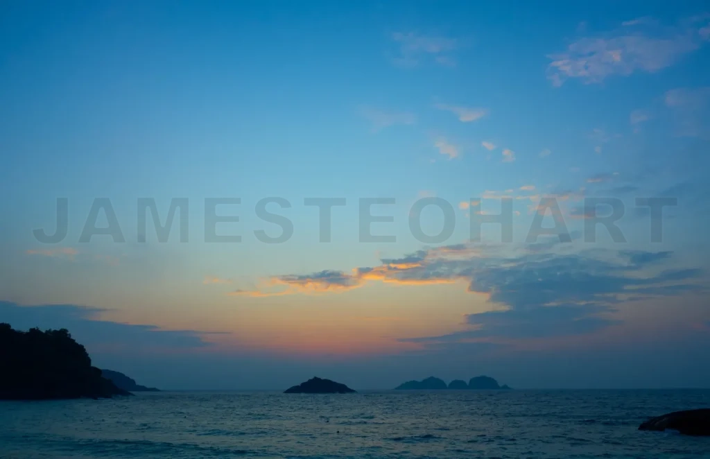 
Orange and blue sky creating a beautiful sunrise over islands in malaysia