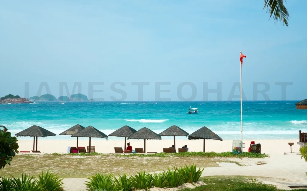 
Tourists relaxing under parasols on a tropical beach in malaysia