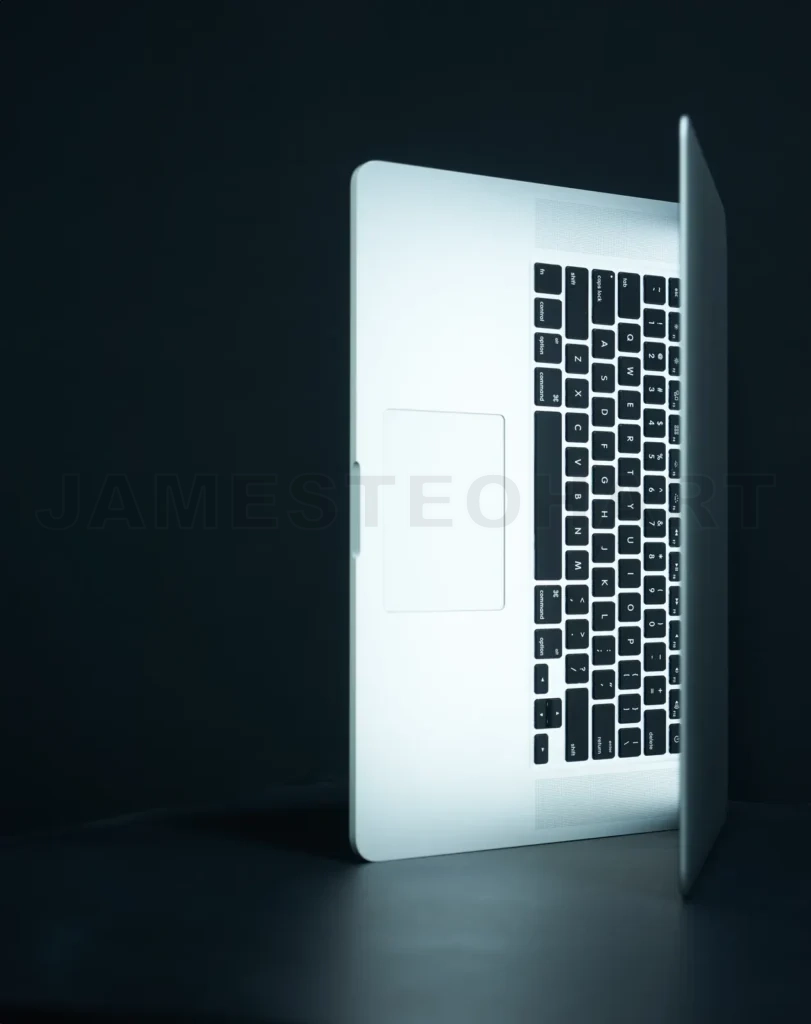 
Laptop with glowing screen on dark background