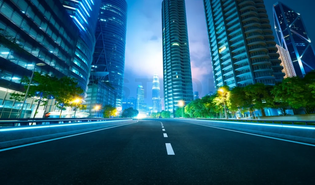 
Asphalt road leading to kuala lumpur city center at night