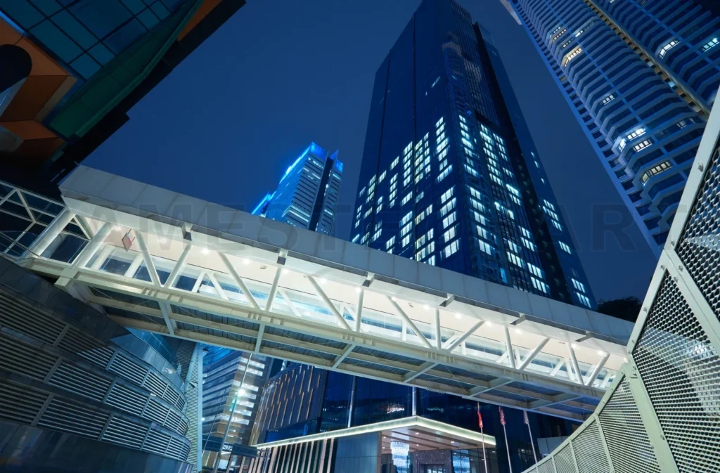 
Low Angle View Of Walkway Bridge And Skyscraper Office Building , Night Scene