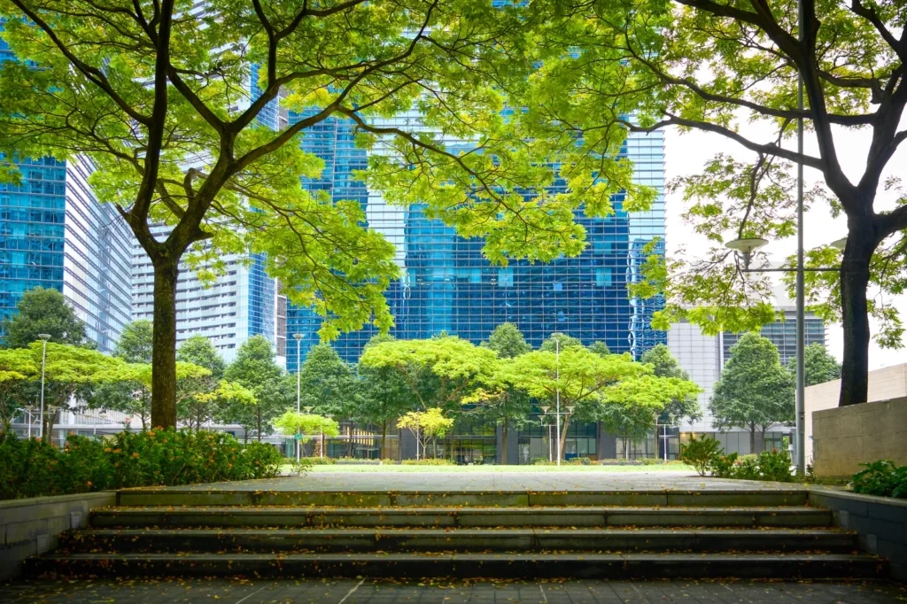 
Urban park with modern glass buildings and trees