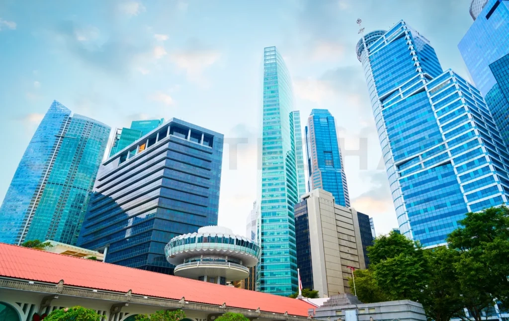 
Modern skyscrapers rising above traditional rooftops in singapore’s bustling cbd
