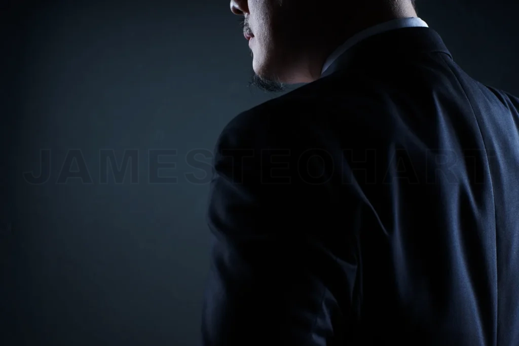 
Closeup Three Quarter Rear View Of Businessman With Black Background
