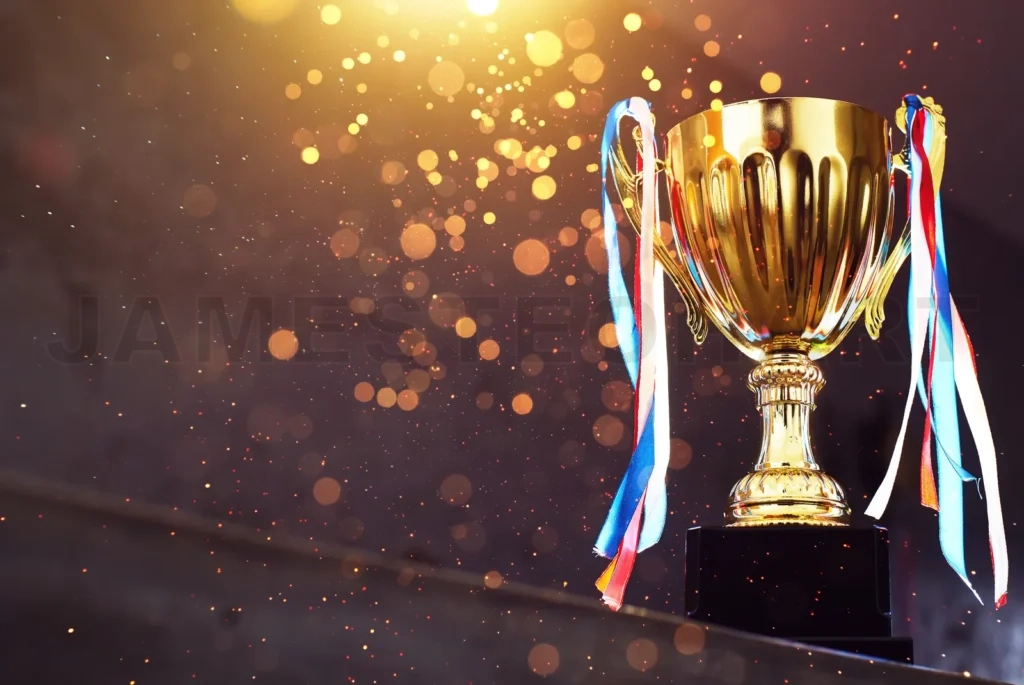 
Low Key Golden Trophy On The Blur Gray Background With Abstract Shiny Lights