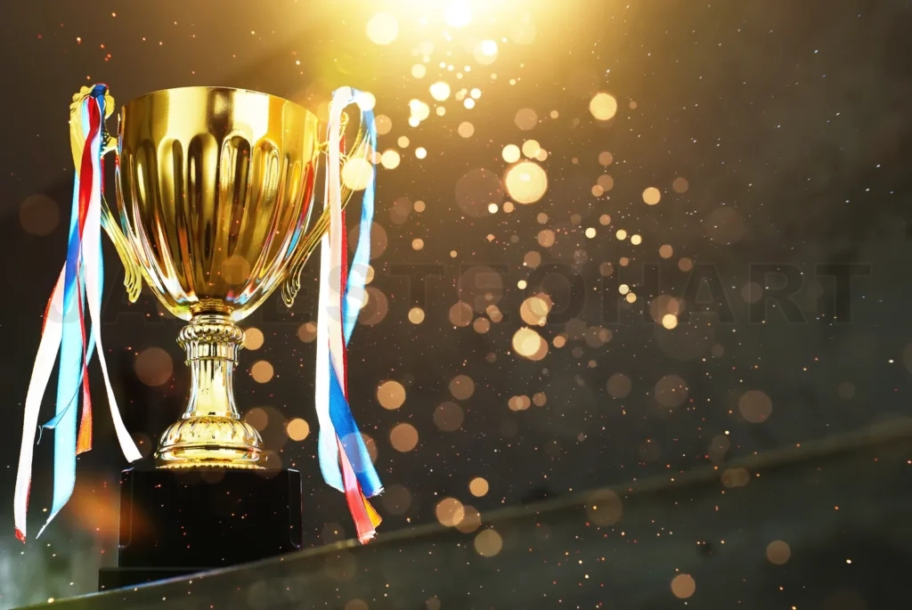 
Low Key Golden Trophy On The Blur Gray Background With Abstract Shiny Lights