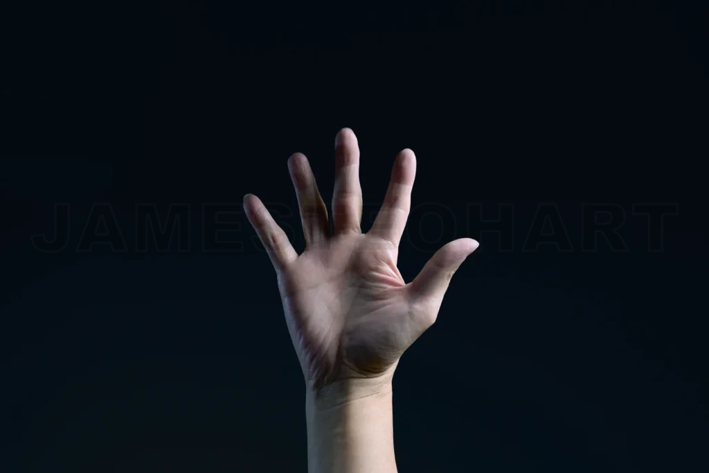 
Open hand reaching out on dark background symbolizing help and support
