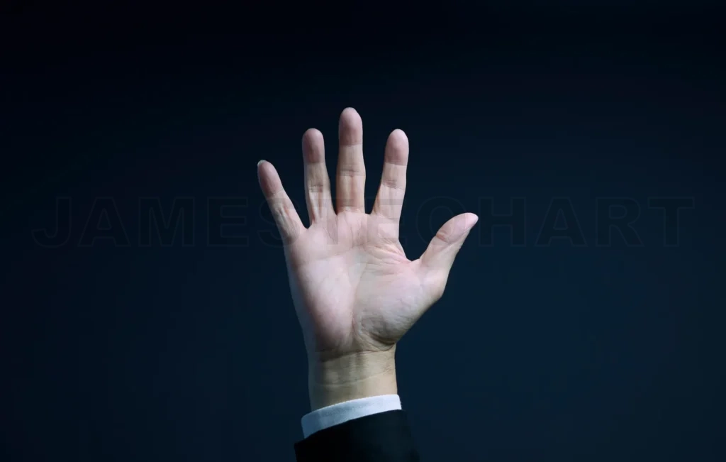 
Businessman showing open hand on dark background