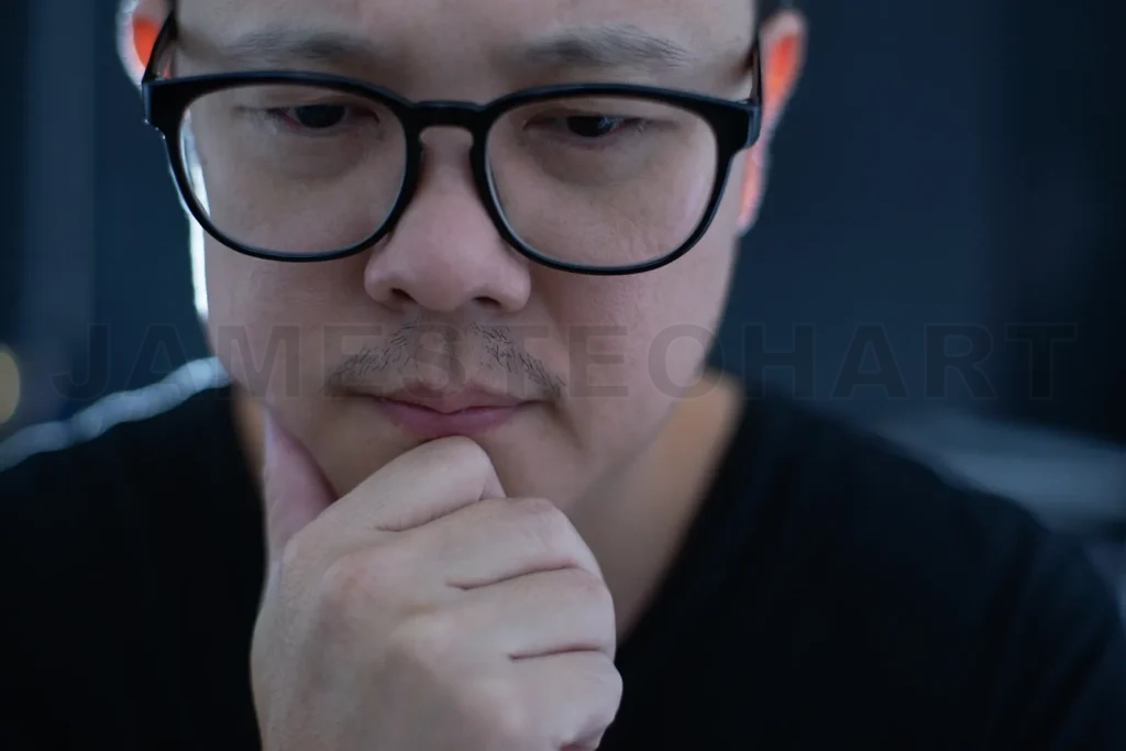 
Portrait Of Serious Young Asian Businessman Looking At Camera