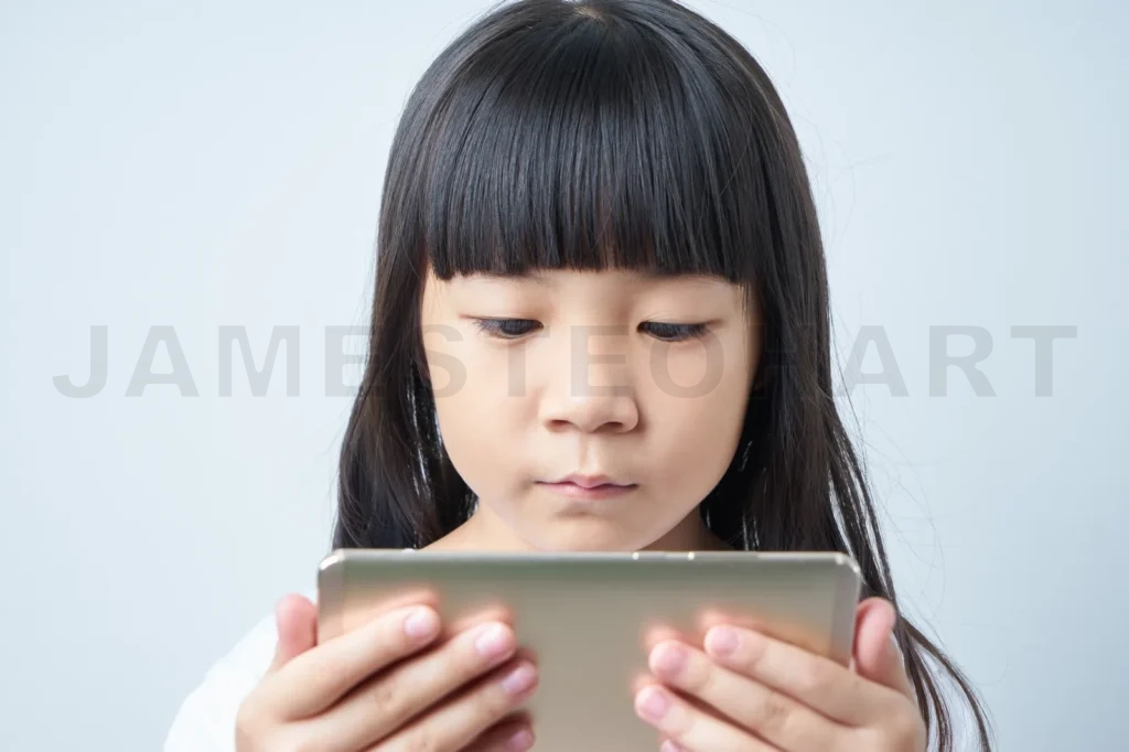 
Little Asian Chinese Girl Using Smartphone