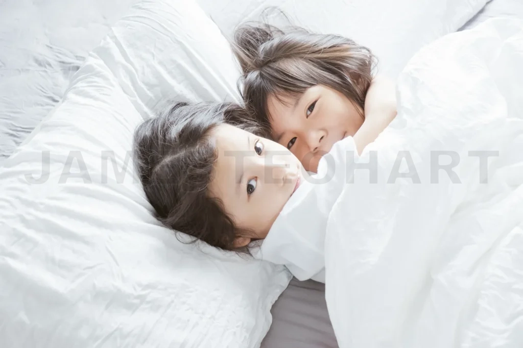 
Two Little Asian Chinese Girl Hug Together And Lying On The Bed