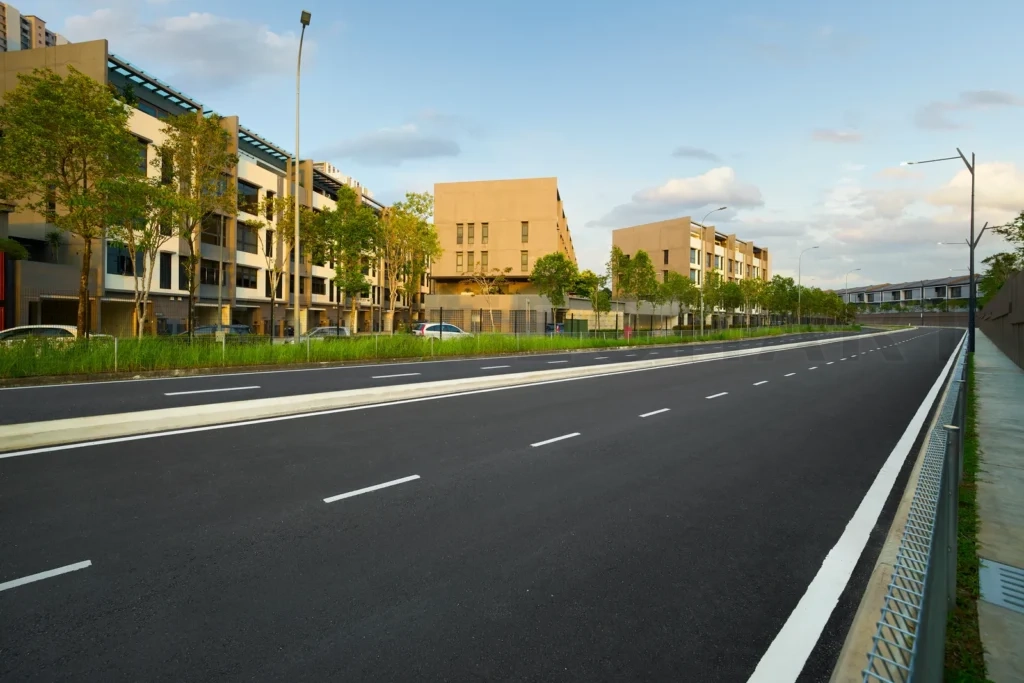 
Urban street leading past modern apartment buildings