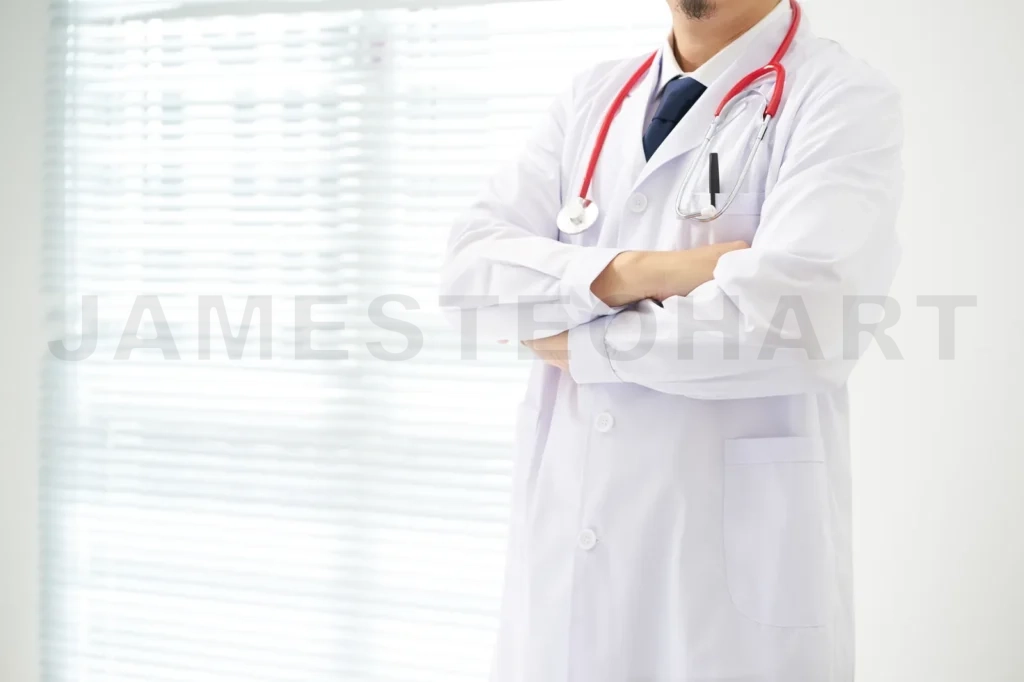 
Unknow Doctor Posing With Arms Crossed In The Office, He Is Wearing A Stethoscope