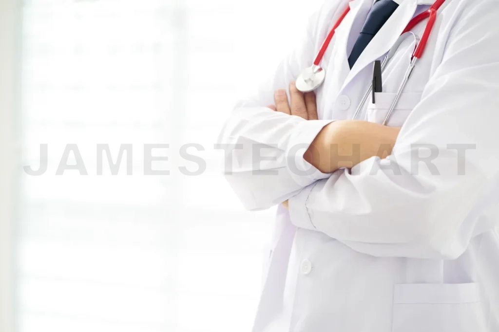 
Unknow Doctor Posing With Arms Crossed In The Office, He Is Wearing A Stethoscope