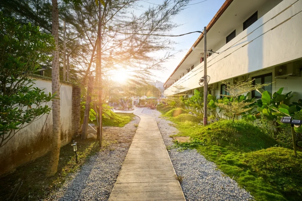 
Resort garden walkway leading to hotel rooms at sunset