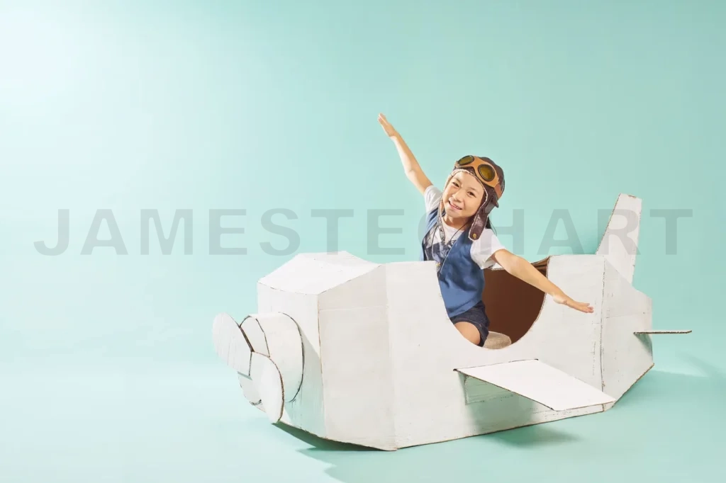 
Little Cute Girl Playing With A Cardboard Airplane
