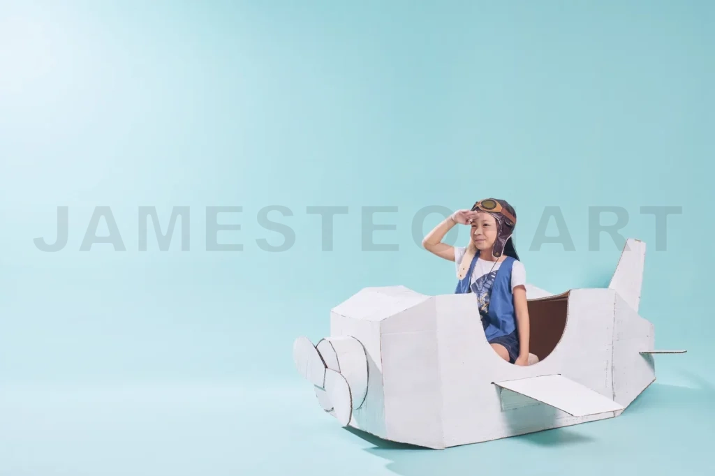 
Little Cute Girl Playing With A Cardboard Airplane