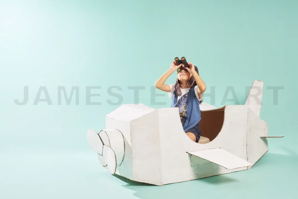 
Little Cute Girl Playing With A Cardboard Airplane