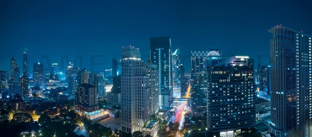 
Bangkok city skyline at night with urban skyscrapers and light trails