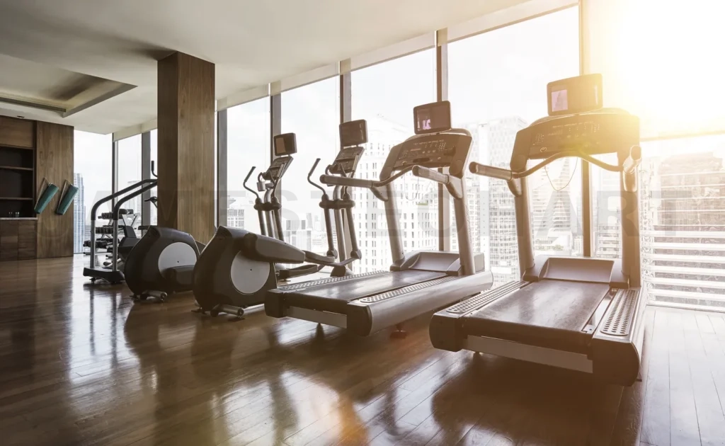 
Modern fitness center with treadmills and city view