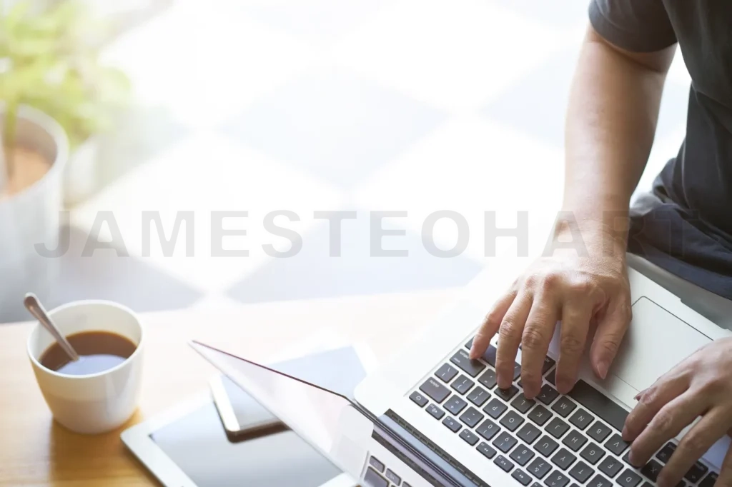 
Laptop In Businessman Hand With Digital Tablet,Smartphone And Coffee