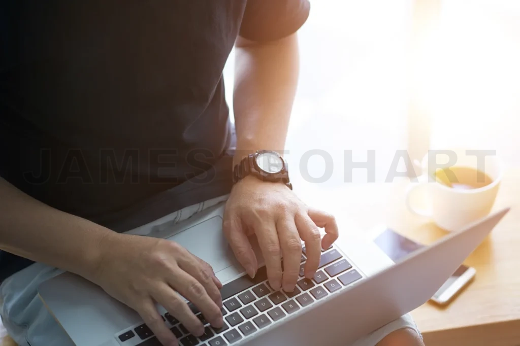 
Laptop In Businessman Hand With Smartphone And Coffee
