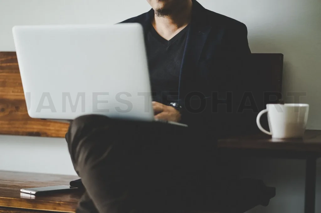 
Businessman Sit On Wooden Chair With Coffee And Using Laptop , Selective Focusing