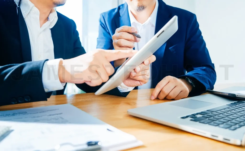 
Two Businessman Using Digital Tablet To Discuss Finance And Marketing Solution