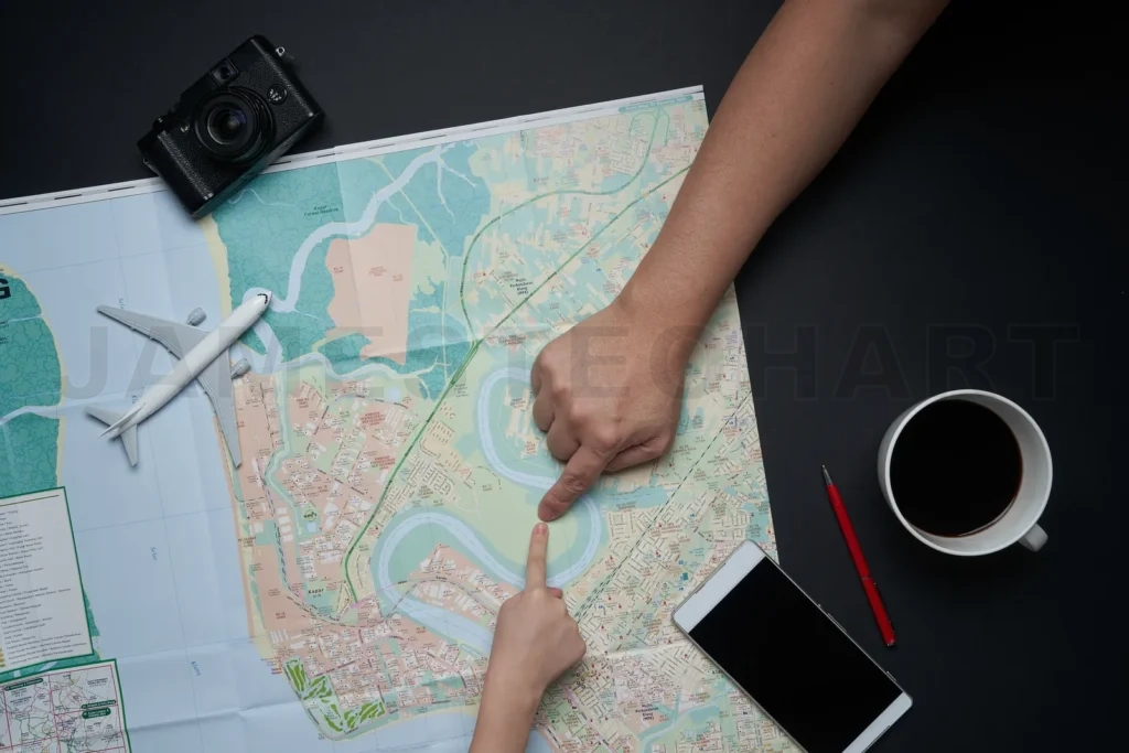 
Hands pointing on map planning travel itinerary