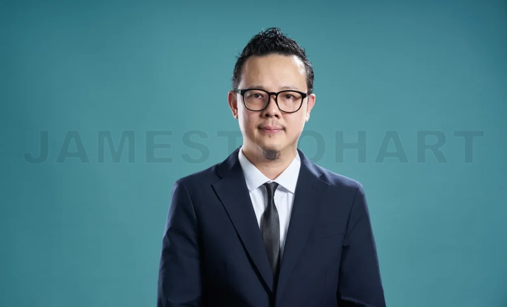 
Confident businessman with glasses on teal background