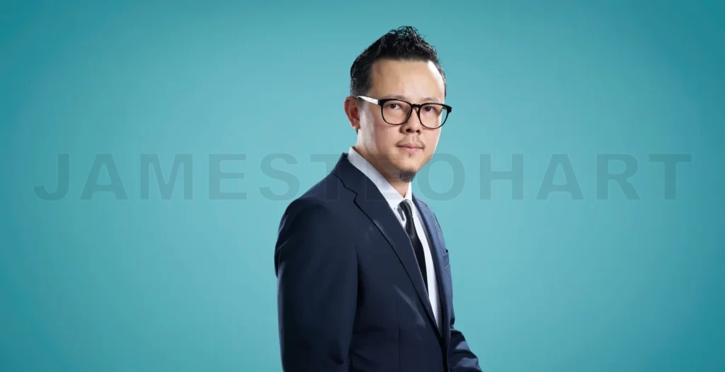 
Portrait of a serious businessman with glasses, standing against
