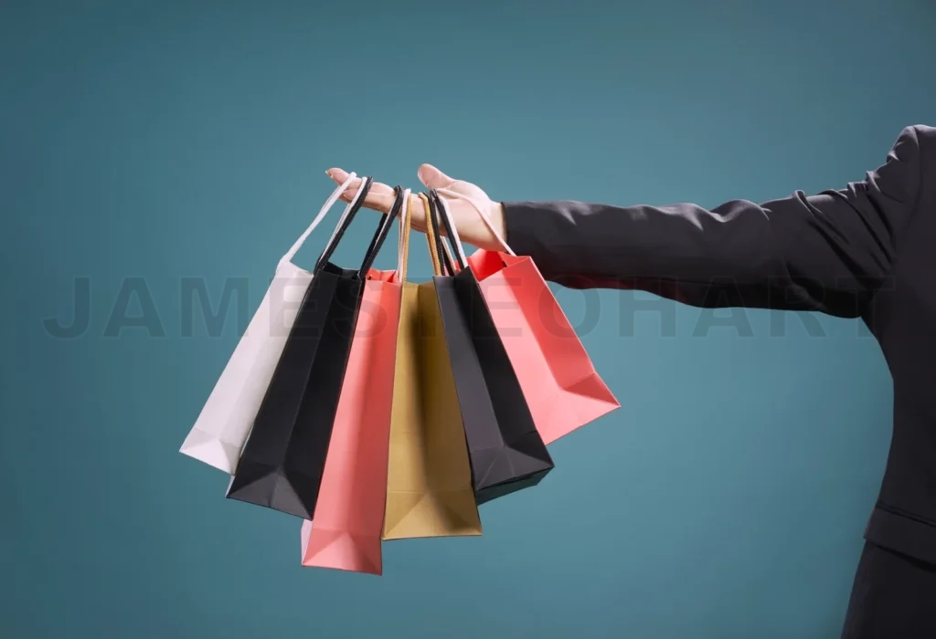 
Close Up Of Man Hand With Shopping Bags , Isolated On Light Blue Background