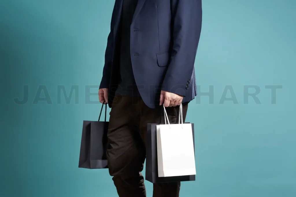 
Close Up Of Man  In Suit With Shopping Bags , Isolated On Light Blue Background