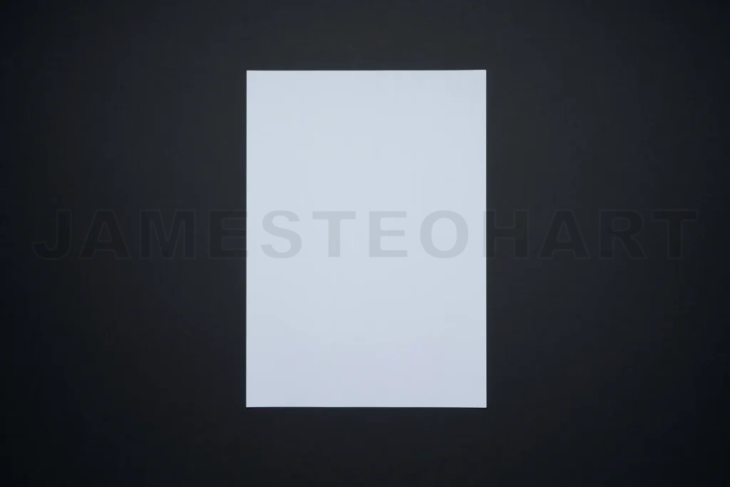 
Blank white paper sheet on black background