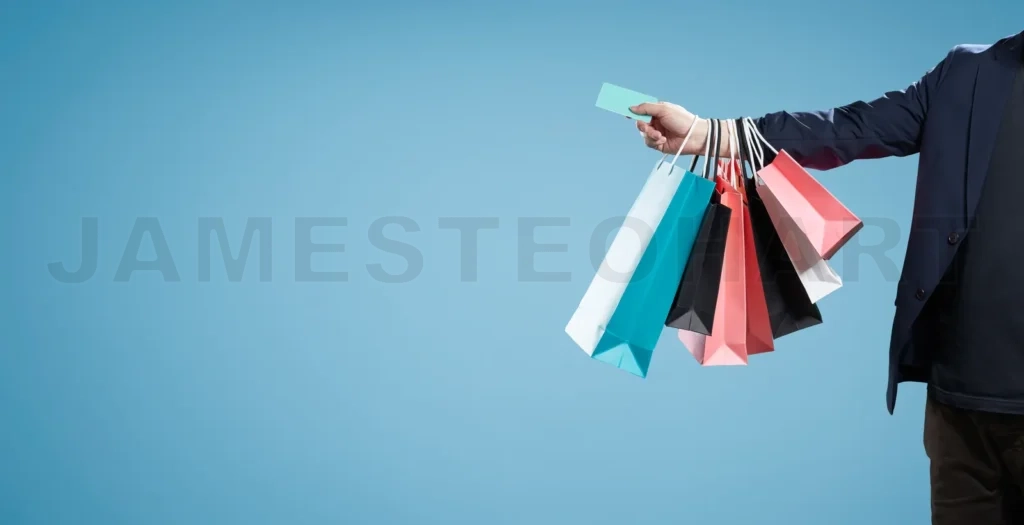 
Man holding multiple shopping bags on blue background