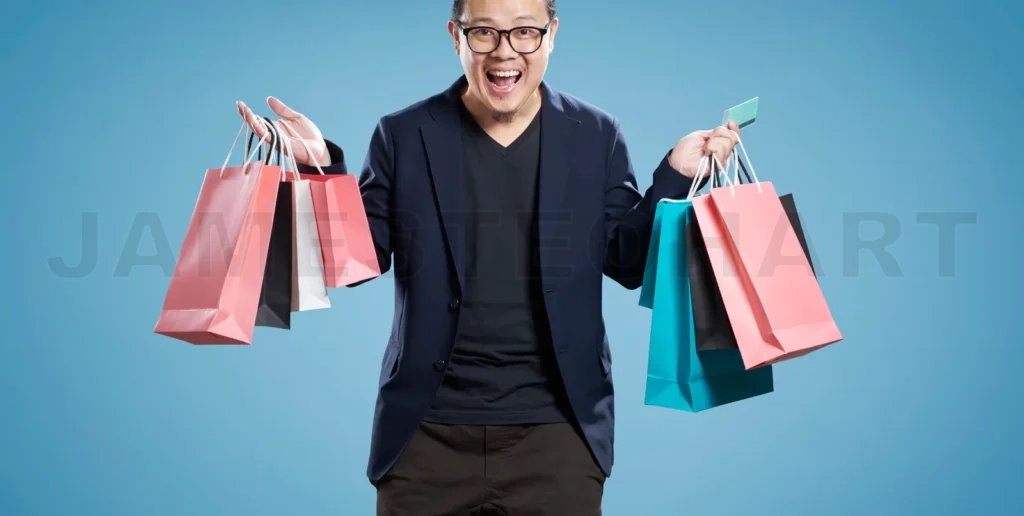 
Excited man holding shopping bags and credit card on blue background