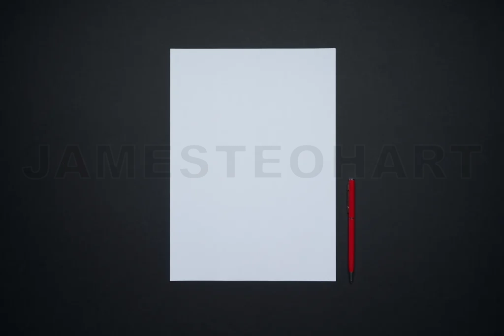 
Blank white paper sheet with red pen on black background