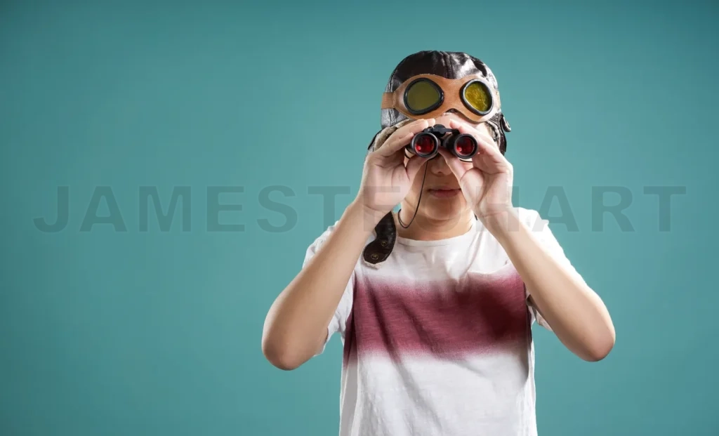 
Smart Kid Using Binoculars Facing Camera