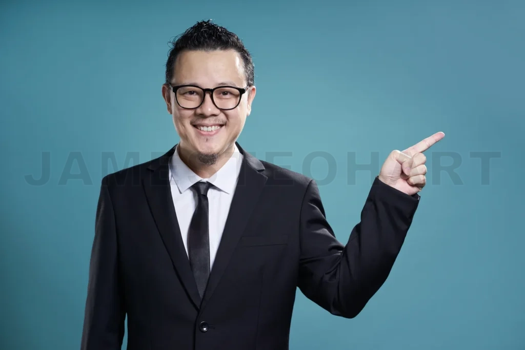 
Asian Businessman Finger Pointing To The Side