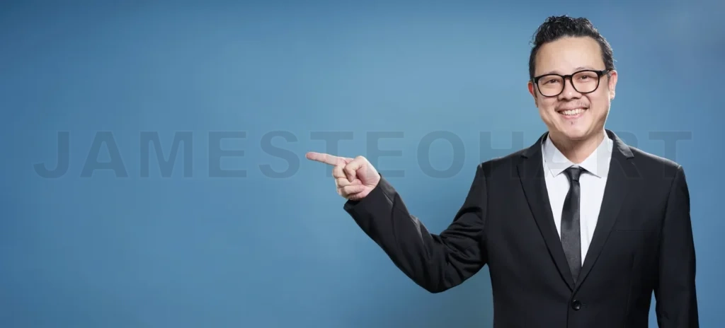 
Portrait of asian businessman smile and points with finger