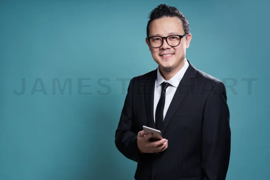 
Portrait Of Smile Asian Businessman In Suit With Using Smartphone