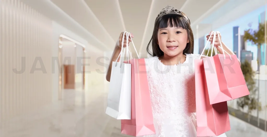
Little girl holding shopping bags in mall corridor