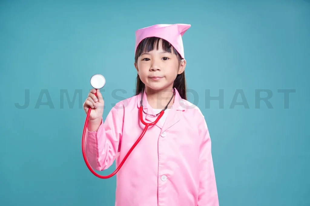 
Little Cute Asian Girl Wear Medical Suit ,Kid Dream Become  Nurse Or Doctor Concept
